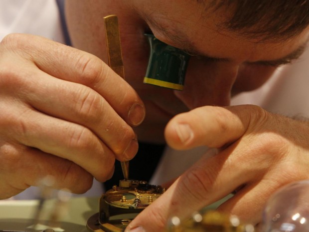 A watchmaker works on a watch mechanism at the Baselworld trade show in Basel, Switzerland Michele Tantussi/Getty Images